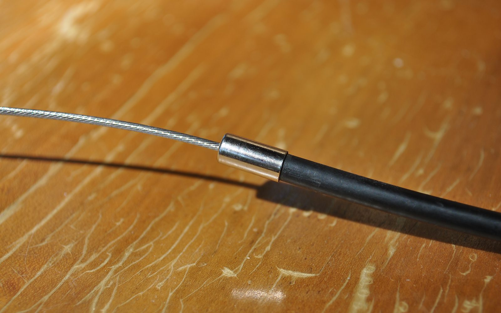 Bowden cable with metal ferrule